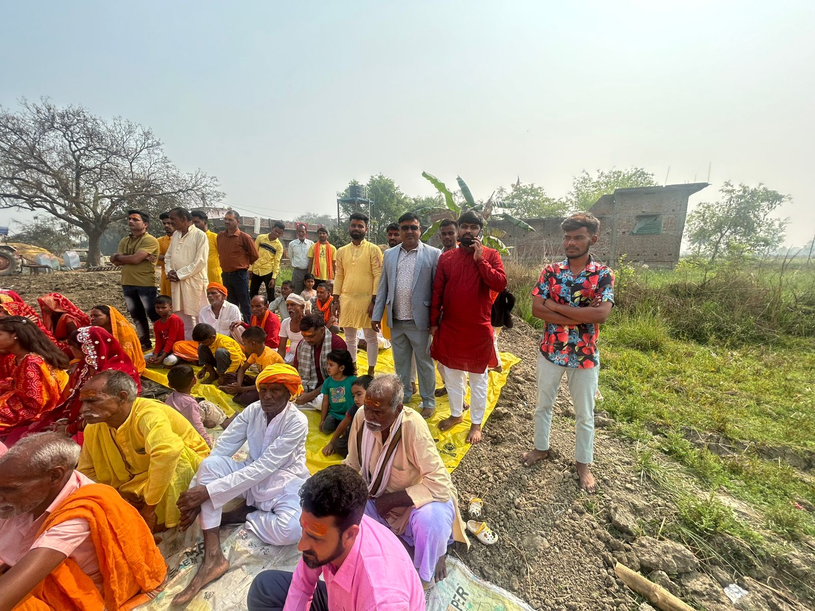 Community members seated together during the puja program